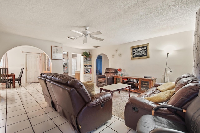1801 SW Beeker St S, Port Saint Lucie, FL 34953 - living area featuring arched walkways, light tile patterned floors, ceiling fan, and a textured ceiling