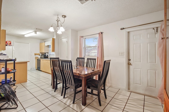 tiled dining area featuring a notable chandelier and a textured ceiling