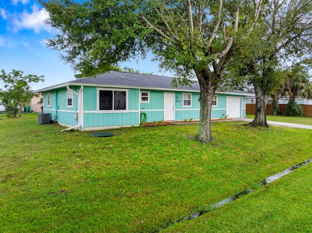 ranch-style house with central air condition unit and a front yard