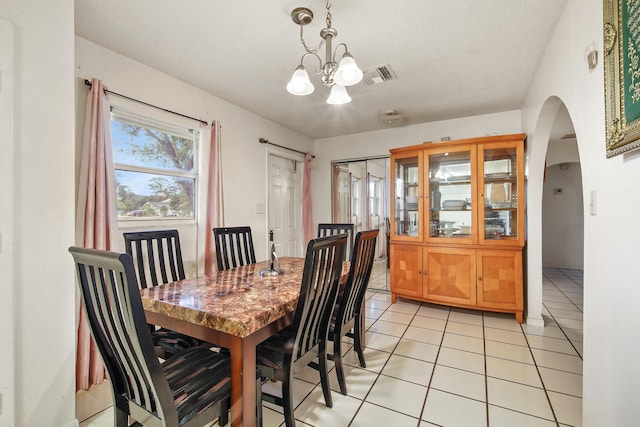 1801 SW Beeker St S, Port Saint Lucie, FL 34953 - dining area with arched walkways, light tile patterned floors, and a chandelier