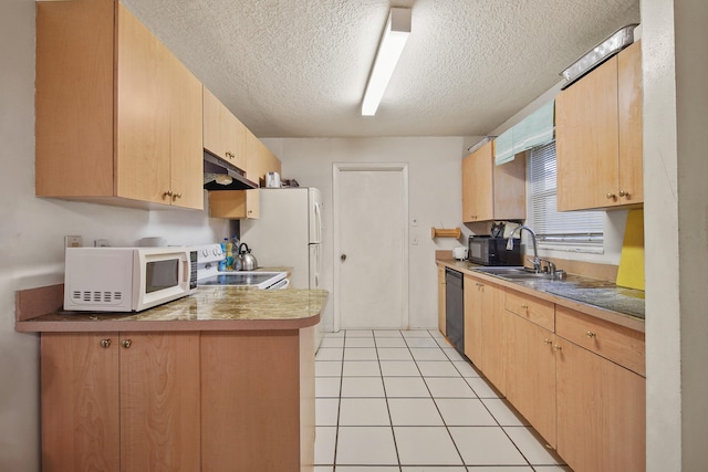 kitchen featuring light brown cabinetry, light tile patterned floors, dishwasher, and stainless steel range oven