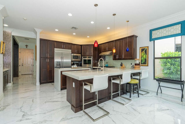 kitchen with built in appliances, kitchen peninsula, decorative light fixtures, a kitchen bar, and ornamental molding