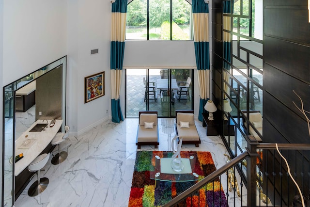 living room featuring a towering ceiling