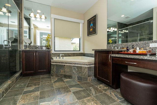 bathroom with vanity and shower with separate bathtub