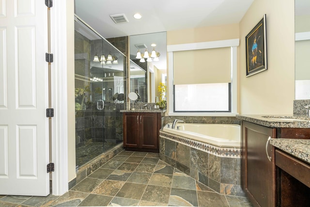 bathroom with vanity and independent shower and bath