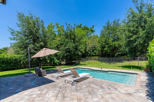 view of swimming pool with a lawn and a patio