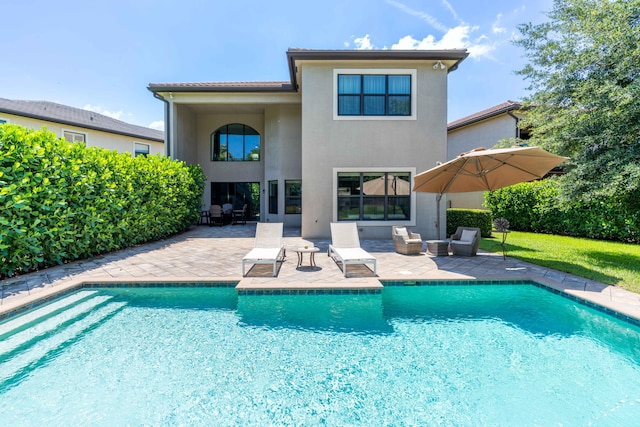 back of property featuring outdoor lounge area and a patio