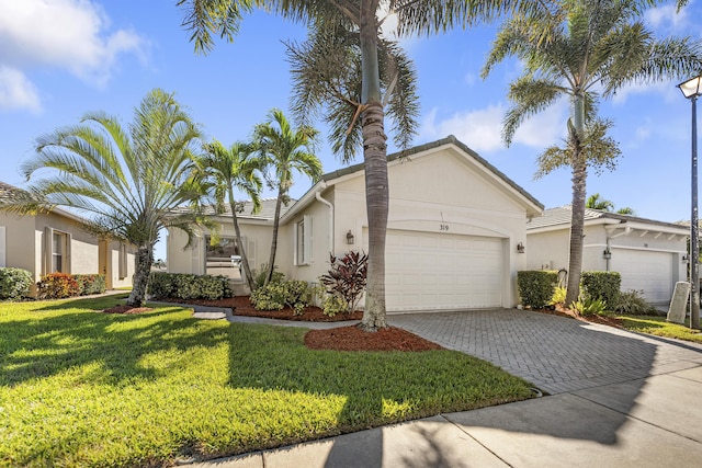 view of front facade featuring a garage and a front lawn