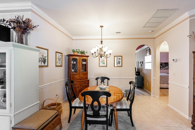 dining area featuring light tile patterned floors, a chandelier, and ornamental molding