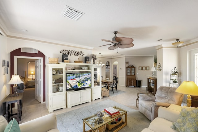 tiled living room featuring ceiling fan with notable chandelier and ornamental molding