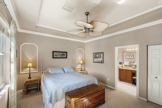 bedroom featuring light carpet, ensuite bathroom, ornamental molding, a raised ceiling, and ceiling fan