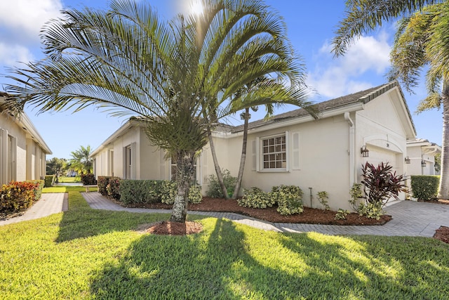 view of property exterior with a lawn and a garage