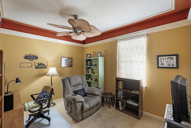 sitting room with a textured ceiling, light colored carpet, and ceiling fan