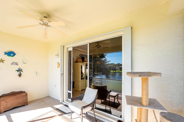 view of patio / terrace with a water view and ceiling fan