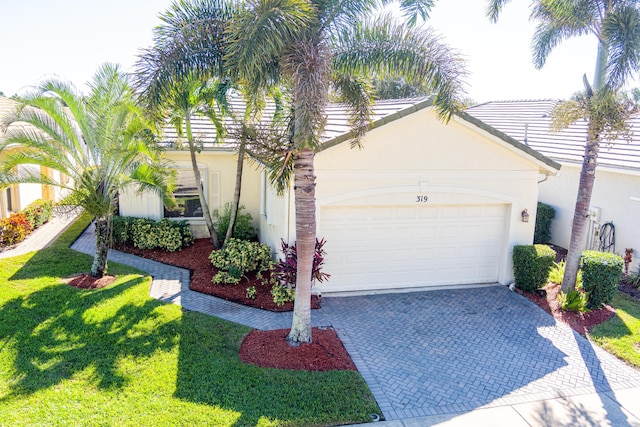 view of front of home with a front yard and a garage