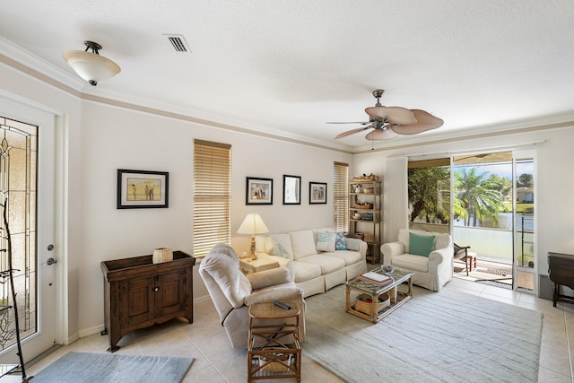 tiled living room with crown molding and ceiling fan