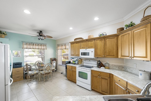 kitchen with white appliances, ceiling fan, ornamental molding, and sink