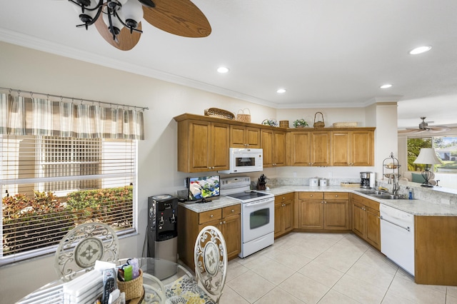 kitchen with a healthy amount of sunlight, white appliances, and crown molding