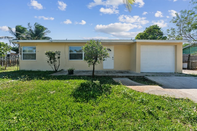 ranch-style home with a front lawn and a garage