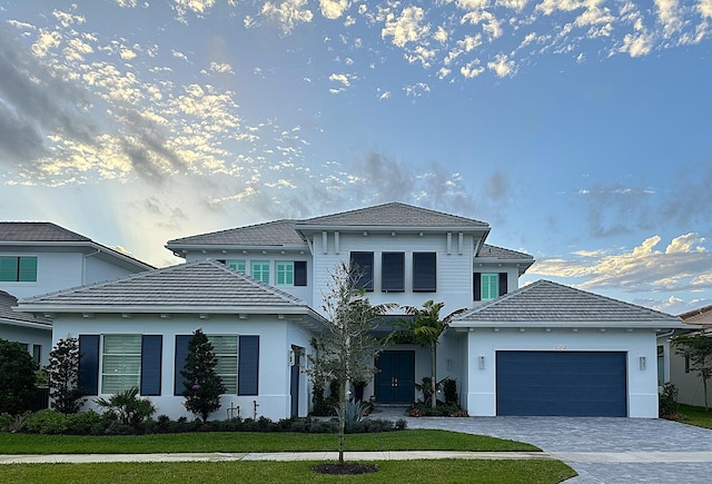 view of front of house with a garage and a front yard