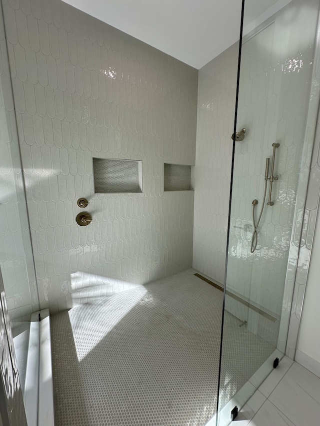 full bathroom with tile patterned flooring and walk in shower