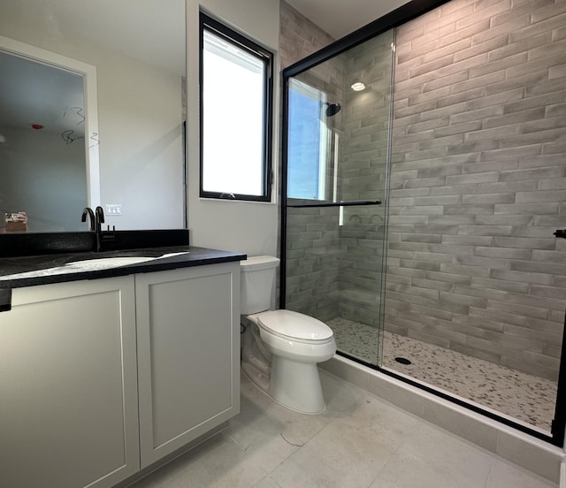 full bathroom with toilet, a stall shower, tile patterned floors, and vanity