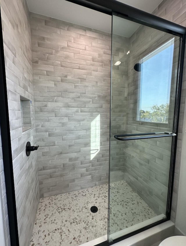 full bathroom featuring a shower stall