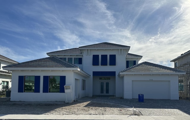 back of house with french doors and a garage