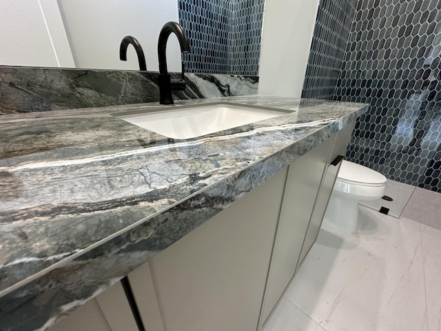 bathroom featuring vanity, toilet, and tile patterned floors