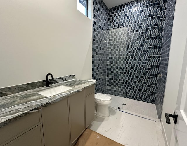 bathroom with vanity, toilet, and walk in shower