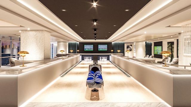 recreation room with bowling and a tray ceiling