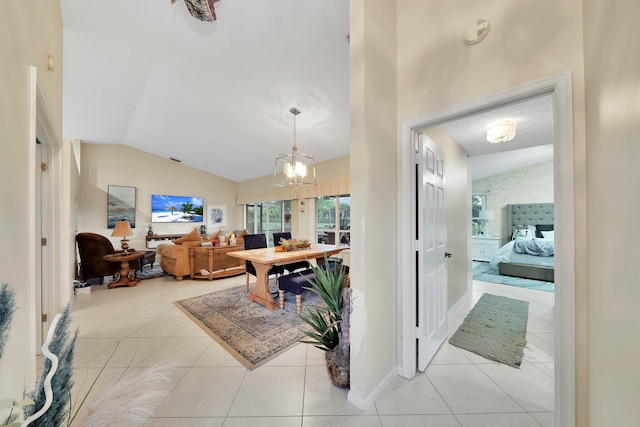 interior space featuring light tile patterned floors, lofted ceiling, and an inviting chandelier