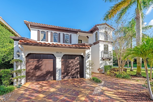 mediterranean / spanish home with a garage