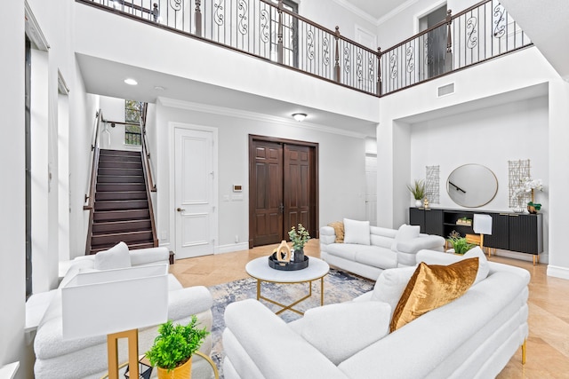 tiled living room featuring a high ceiling and ornamental molding