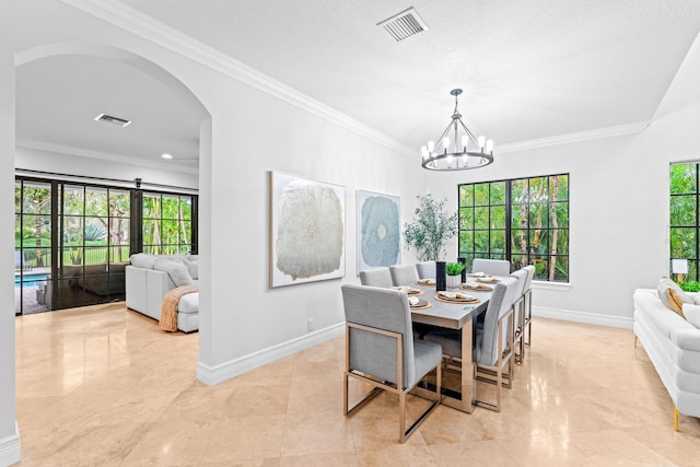 dining room featuring a healthy amount of sunlight, an inviting chandelier, crown molding, and a textured ceiling