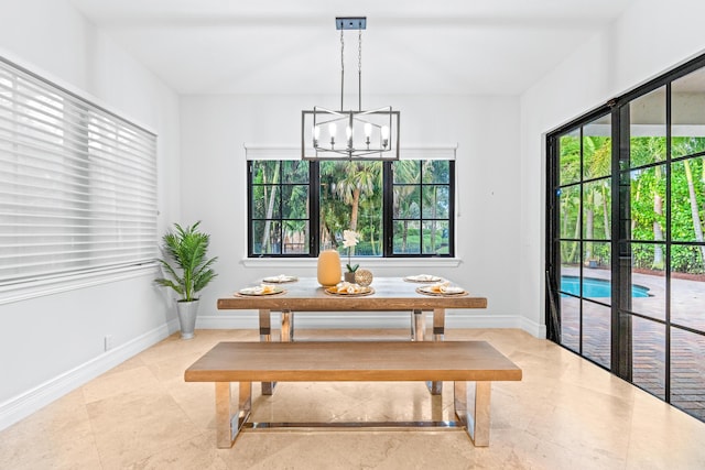 dining area with a chandelier and french doors