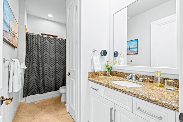 bathroom featuring tile patterned flooring, curtained shower, vanity, and toilet