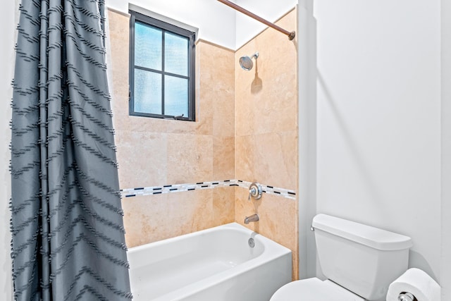 bathroom featuring toilet and shower / tub combo