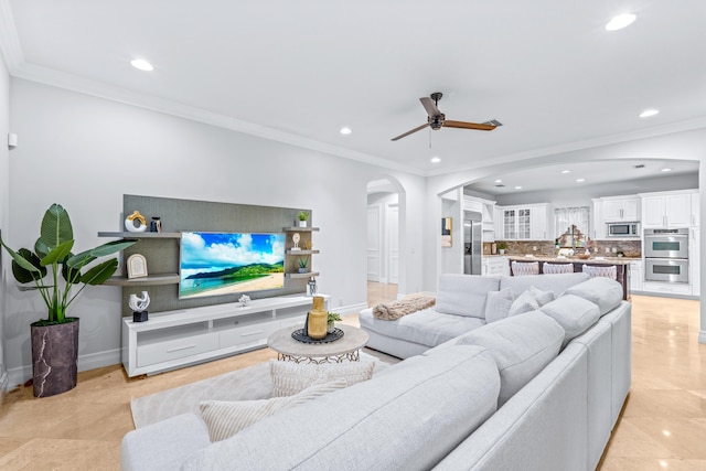 living room featuring ceiling fan, crown molding, and light tile patterned floors