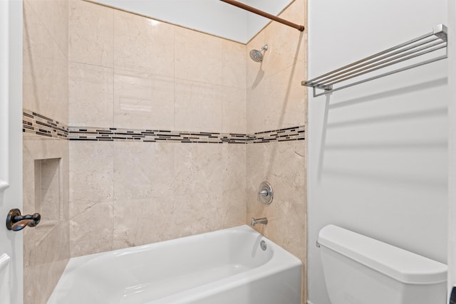 bathroom with toilet and tiled shower / bath combo