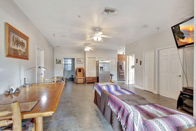 living room with tile patterned floors and ceiling fan