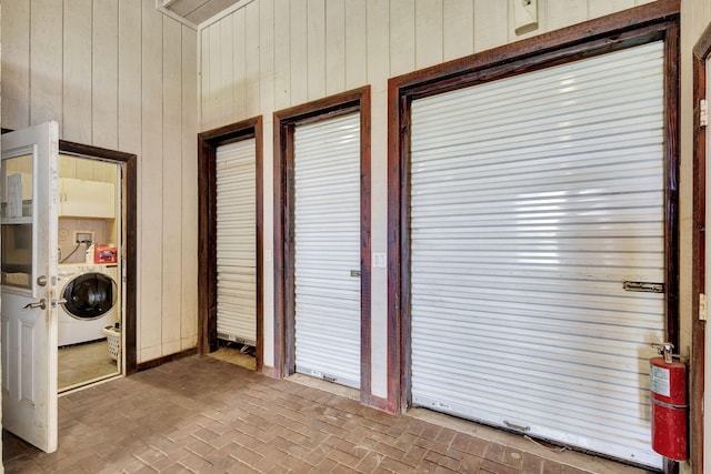 interior space featuring washer / dryer and wood walls