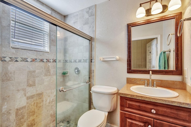 bathroom with vanity, toilet, and an enclosed shower