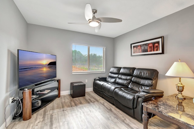 living room with light hardwood / wood-style floors and ceiling fan