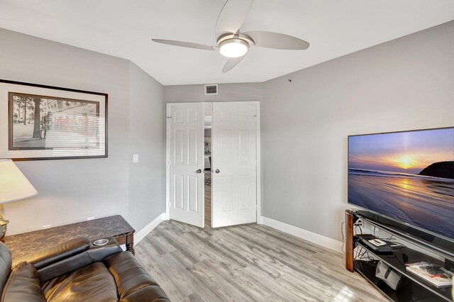 living room featuring ceiling fan and light wood-type flooring