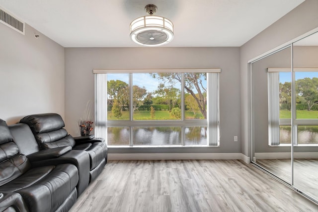 living room with a wealth of natural light and light wood-type flooring