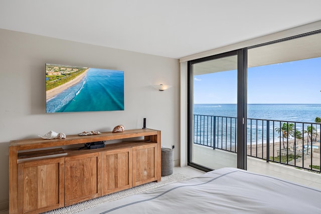 carpeted bedroom featuring multiple windows, a water view, and access to exterior