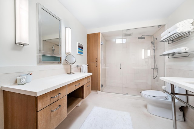 bathroom with vanity, toilet, and walk in shower