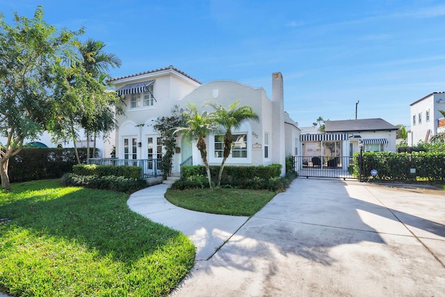 mediterranean / spanish-style home with a front yard