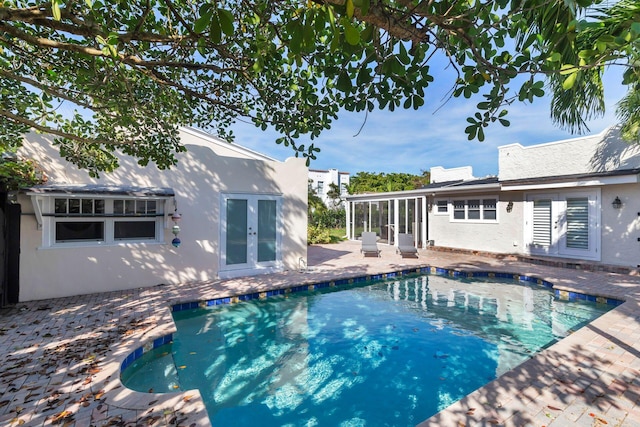 view of pool featuring french doors